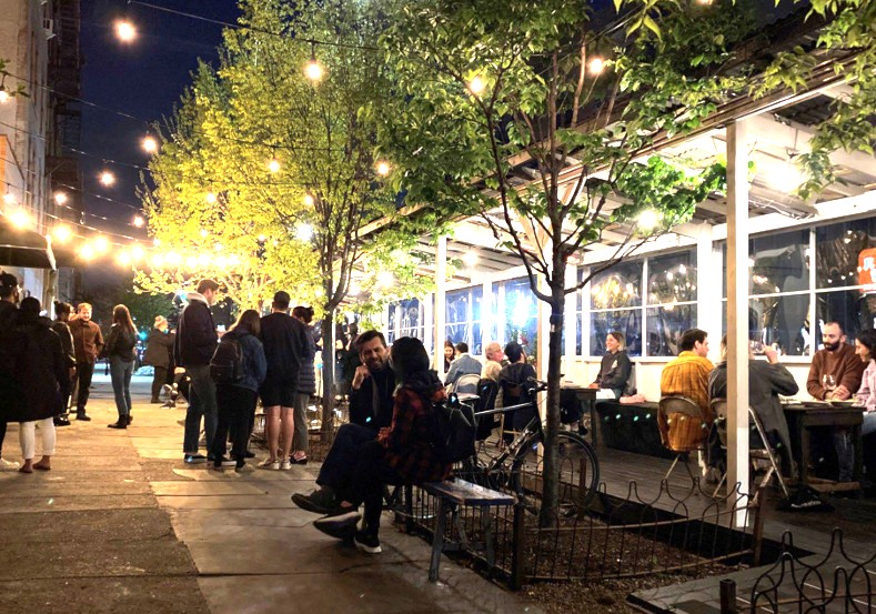 People dining outdoors at night