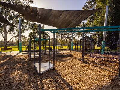 A snapshot capturing a full view of the new playground at Burwood Reserve, with sunlight streaming through